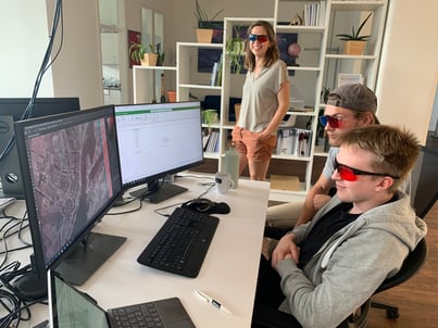 No boring work: north.io working students Anton & Linus demonstrate the use of 3D glasses. These make it possible to view the referenced aerial war images in such a way that bomb craters and hits are clearly visible.